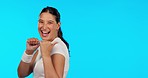 Woman, thumbs up and fitness studio with space, pointing and smile on face for promotion by blue background. Girl, sports and happy for health promo, exercise mockup and good review for feedback