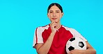 Young woman, soccer and thinking with ball, ideas and vision for career, mindset or face by blue background. Girl, football player and professional sports person with focus, choice and dream on brain
