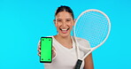 Phone, green screen and a woman tennis player on a blue background in studio for sports marketing. Portrait, smile and fitness with a female athlete holding chromakey mockup on a mobile screen