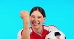 Face, soccer or woman with celebration, champion or female person against a blue studio background. Portrait, athlete or football player with winner, success or goal with fist, achievement or winning