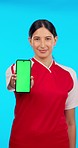 Sports branding, green screen phone and a woman with soccer information or promotion. Showing app, sport and a face portrait of a football player with a blank mobile with space on a blue background