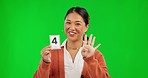 Asian woman, teaching and counting numbers for learning on green screen against a studio background. Portrait of happy female person or teacher explaining number and finger count for math education
