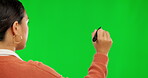 Woman, writing and pen on green screen or mockup for presentation against a studio background. Hands of female person in write, drawing or message for question, strategy or ideas on chromakey space