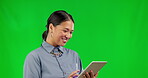 Happy asian woman, tablet and laughing on green screen for funny joke or social media against a studio background. Female person, laugh and smile on technology for networking, meme or communication