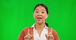 Asian woman, pointing and explaining in presentation on green screen against a studio background. Portrait of happy female person or teacher in online learning, advertising or discussion on chromakey