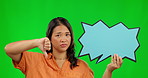 Thumbs down, speech bubble and rejection with an asian woman on a green screen background. Poster, emoji and social media with an unhappy female model in studio to dislike a post on chromakey mockup