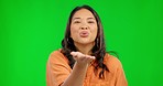 Face, green screen and Asian woman blowing kiss, love and happy girl against a studio background. Portrait, female person and model with air kissing, emoji and loving with romance, smile and flirting