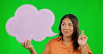 Asian woman, speech bubble and fingers crossed on green screen for luck against a studio background. Portrait of female person with icon or shape in hope for news, feedback or social media comment