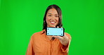 Happy woman, phone and mockup on green screen for advertising against a studio background. Portrait of female person showing mobile smartphone app with mock up display, tracking markers and chromakey