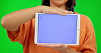 Woman, chroma key and hands on tablet for advertising, marketing or promotion on green screen for business, announcement. Technology, display and digital branding for online, web or mobile app 