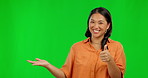 Happy asian woman, hands and thumbs up on green screen for success against a studio background. Portrait of female person with smile and thumb emoji, yes sign or like for approval in advertisement