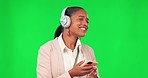 Business woman, headphones and phone on green screen for music, dancing and fun. Female model person with smartphone for listening to audio sound with fun energy, smile and motivation in studio