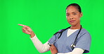 Nurse, woman pointing and green screen in healthcare presentation, information or advertising services. Face of medical person or doctor hand to show health list, mockup or space on studio background