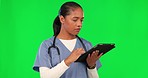 Tablet, green screen and female nurse in studio for medical research or telehealth diagnosis. Healthcare, analysis and woman doctor scrolling on digital technology isolated by a chroma key background