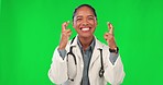 Face, woman and doctor with fingers crossed, green screen and healthcare with happiness, hope and luck. Portrait, female person and medical professional with hand gesture, wish and gratitude with joy