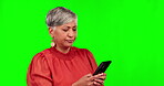 Frustrated, phone and confused with business woman on green screen for news, social media and networking. Anger, feedback and busy with senior employee on studio background for contact and online