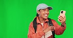 Hiking, woman and phone for video call on green screen with network connection. Young female influencer person with a backpack and smartphone on a studio background talking about travel content