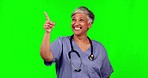 Green screen, happy woman and senior doctor pointing at hospital service announcement, clinic notification or medical info. Chroma key surgeon, nurse promo and healthcare person on studio background