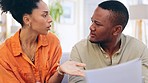 Stress, documents and couple on couch, finance problem and conversation for budget, planning and upset. Partners, black man and woman with paperwork, mortgage expenses or talking in home with crisis