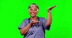 Green screen, happy woman and senior doctor gesture at hospital announcement, clinic nurse promotion or medicine info. Chroma key portrait, cardiology promo and healthcare person on studio background