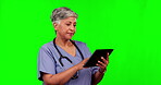 Nurse, senior woman and tablet on green screen in studio isolated on a background mockup. Medical professional, technology and confused surgeon thinking, problem solving or frustrated with healthcare