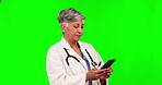 Online communication, female doctor on her smartphone and social networking against a green screen. Connectivity or technology, mockup space and woman surgeon typing an email on her cellphone.