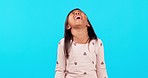 Crying, sad and child on a green screen with a tantrum isolated on a blue background in a studio. Stress, fear and a young girl with expression of emotion, tears and frustrated with a problem