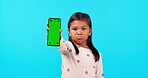 Phone, green screen and a moody girl on a blue background in studio for marketing or advertising. Kids, branding and an unhappy child holding chromakey mockup with tracking markers on a blank display