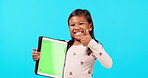 Happy girl, thumbs up and tablet on mockup for social media advertising against a blue studio background. Portrait of female child smile with like emoji, yes sign or approval for technology success