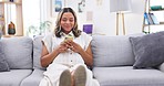 Happy woman, sofa and laugh at phone text at home with smile and social media in living room. Relax, digital and young female person on mobile with web chat and online communication on a house couch