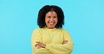 Smile, funny and arms crossed with a black woman on a blue background in studio for comedy or humor. Portrait, comic and laughter with a happy young afro female person looking cheerful or carefree