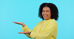 Face, funny and woman with hand presentation in studio isolated on blue background. Portrait, mockup palm or African person with gesture for marketing, commercial brand or laugh at advertising space