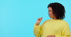 List, options and pointing with a black woman on a blue background in studio for instructions or a tutorial. Portrait, how to and gesture with a happy young afro female person looking confident