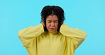 Scared, fear and a woman with ptsd on a green screen isolated on a blue background in a studio. Mental health, angry and a crazy or frustrated girl covering ears from noise or anxiety problem