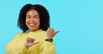 Funny, face and woman point to mockup in studio isolated on a blue background. Portrait, space and African person with hand gesture for marketing, branding and laughing at advertising commercial.