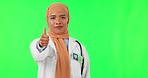Muslim woman, doctor and thumbs up in confidence on green screen for success against a studio background. Portrait of female medical or healthcare professional with like emoji, yes sign or approval