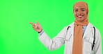 Muslim woman, doctor and pointing on green screen for advertising against a studio background. Portrait of female person, medical or healthcare professional point for advertisement on mockup space
