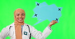 Muslim woman, doctor and speech bubble on green screen for social media against a studio background. Portrait of female medical or healthcare professional pointing to icon, chat or message on mockup