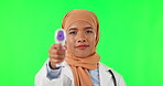 Thermometer, face and a Muslim doctor on a green screen for healthcare and medical check. Nursing, care and portrait of an Islamic nurse with a tool for a fever isolated on a studio background