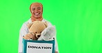 Healthcare, Muslim and a doctor with a donation on a green screen for charity, service and care. Happy, face portrait and an Islamic surgeon with a box of toys isolated on a mockup studio background