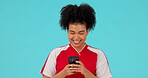 Phone, soccer and smile with woman in studio for communication, social media and networking, Football, fitness and internet with female athlete on blue background for funny, contact and sports