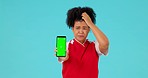 Green screen, stress and woman face with phone for soccer results, score or review on blue background. Smartphone, mockup and portrait of female football player with bad news, disappointed and fail