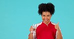 Studio face, wellness and happy woman drinking water, glass drink or beverage for hydration, thirst and refreshment. Liquid, health portrait and person with cold drinks isolated on blue background