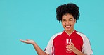 Studio pointing, wellness and happy woman drinking water, glass drink or beverage for hydration, promo or commercial. Portrait, direction and thirsty person with drinks isolated on blue background