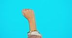 Fist, power and person hand with emoji, gender equality and human rights with activism isolated on blue background. Protest, justice and empowerment with mockup space, activist and revolution