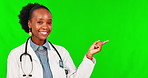 Show, pointing and face of female doctor on green screen for deal, announcement or advertising. Medical, medicine and healthcare with portrait of black woman on studio background for decision mockup
