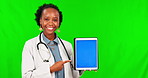 Black woman, doctor and pointing to tablet on green screen for advertising against a studio background. Portrait of African female person in healthcare showing technology, mockup and tracking markers