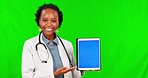 Black woman, doctor and tablet on green screen in advertising against a studio background. Portrait of happy African female person in healthcare showing technology, mockup display or tracking markers