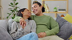 Love, couple holding hands and on sofa happy together in living room of their home together. Intimacy or care, happiness or wellness and married people hug on a couch in their house for support