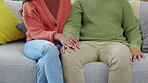 Love, closeup and holding hands with couple on sofa for relax, support and kindness. Affectionate, trust and respect with man and woman in living room at home for commitment, intimate and empathy